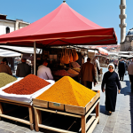 ** A bustling Istanbul marketplace, overflowing with vibrant spices, Turkish delight (lokum), and handwoven carpets. Include diverse shoppers haggling with vendors under colorful awnings, with the iconic silhouette of a mosque in the background. Capture the lively energy and sensory richness of the scene. Style: Realistic, vibrant colors.

**